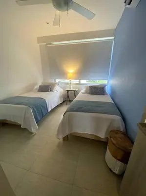a bedroom with two beds and a ceiling fan at Apartamento frente al Mar Cartagena in Cartagena de Indias