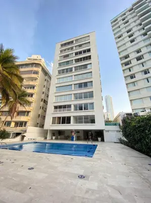 a large building with a swimming pool in front of it at Apartamento frente al Mar Cartagena in Cartagena de Indias