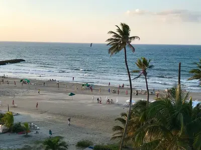 a group of people on a beach with the ocean at Apartamento frente al Mar Cartagena in Cartagena de Indias