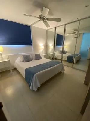 a bedroom with a bed and a ceiling fan at Apartamento frente al Mar Cartagena in Cartagena de Indias