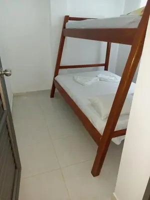 a bedroom with two bunk beds and a tiled floor at Apartamentos Mi Reserva OK - Miraluna in Coveñas