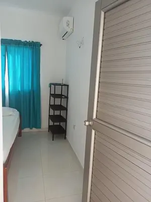 a bathroom with a door and a room with a window at Apartamentos Mi Reserva OK - Miraluna in Coveñas