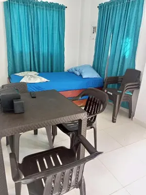 a room with a table and chairs and a bed at Apartamentos Mi Reserva OK - Miraluna in Coveñas