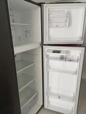 an empty refrigerator with its door open in a kitchen at Apartamentos Mi Reserva OK - Miraluna in Coveñas