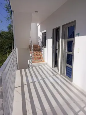 a white house with stairs leading to a door at Apartamentos Mi Reserva OK - Miraluna in Coveñas