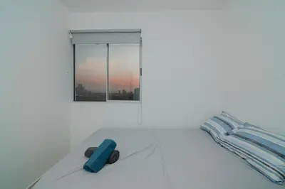 a white bedroom with a bed with a window at Apartamento El Colibri CARTAGENA en TORRE PRIMI in Cartagena de Indias
