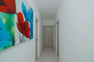 a hallway with a painting on the wall at Apartamento El Colibri CARTAGENA en TORRE PRIMI in Cartagena de Indias