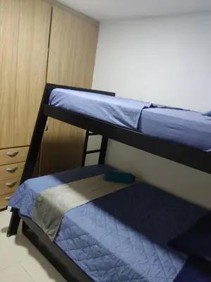 two bunk beds in a room with a cabinet at Apto TORRE PRIMI - Cerca al mar in Cartagena de Indias