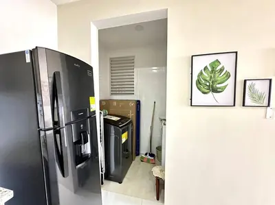 a kitchen with a black refrigerator in a room at Moderno e Iluminado Apartamento in Sincelejo