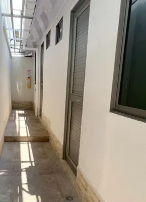 a hallway of a building with a door and a window at Apartaestudio 2 en Barranquilla in Barranquilla