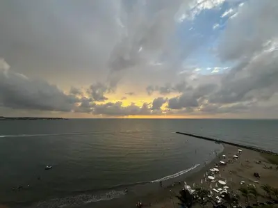 a beach with a cloudy sky and the ocean at Penthouse en Cartagena in Cartagena de Indias