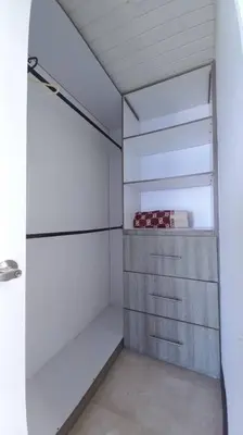 a walk in closet with white walls and a glass door at Penthouse en Cartagena in Cartagena de Indias