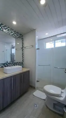 a bathroom with a toilet and a sink and a mirror at Penthouse en Cartagena in Cartagena de Indias