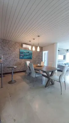 a dining room with a wooden table and chairs at Penthouse en Cartagena in Cartagena de Indias
