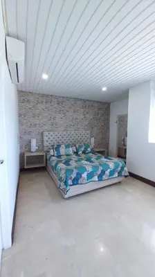 a bedroom with a bed and a brick wall at Penthouse en Cartagena in Cartagena de Indias