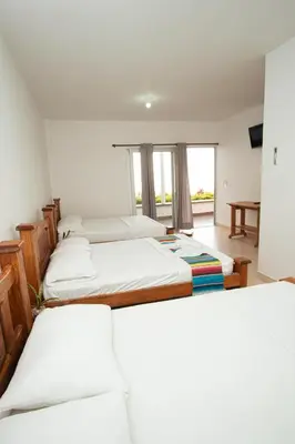 a group of four beds in a room at Hotel Caribe Coveñas in Coveñas
