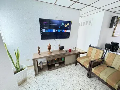 a living room with a flat screen tv on a wall at Casa Ciudad Jardin Centro Histórico in Barranquilla