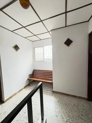 an empty room with a staircase and a window at Casa Ciudad Jardin Centro Histórico in Barranquilla