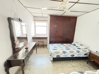 a bedroom with a bed and a ceiling fan at Casa Ciudad Jardin Centro Histórico in Barranquilla