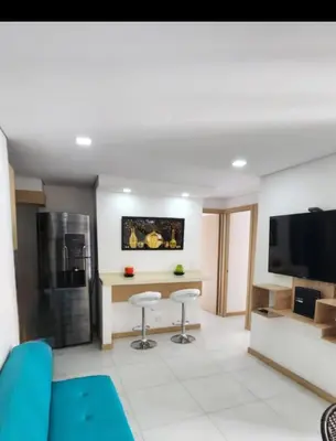 a living room with a table and a tv at Apartamento de Lujo, amoblado en Cartagena in Cartagena de Indias