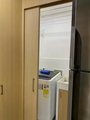 a kitchen with a refrigerator next to a door at Apartamento de Lujo, amoblado en Cartagena in Cartagena de Indias