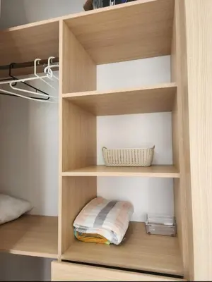 a closet with wooden shelves with a pillow and a basket at Apartamento de Lujo, amoblado en Cartagena in Cartagena de Indias