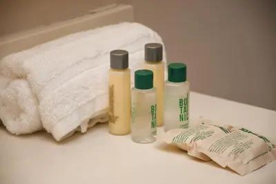 a group of three bottles of lotion on a bathroom counter at Ciela Hotel in Coveñas