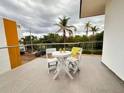 a white table and chairs on a balcony at Casa 5 Brisa Piso 2- Palmar De Los Vientos in San Bernardo del Viento