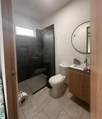 a bathroom with a toilet and a shower and a sink at Casa 5 Brisa Piso 2- Palmar De Los Vientos in San Bernardo del Viento