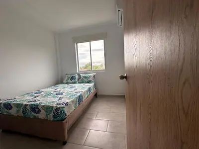 a small bedroom with a bed and a window at Casa 5 Brisa Piso 2- Palmar De Los Vientos in San Bernardo del Viento