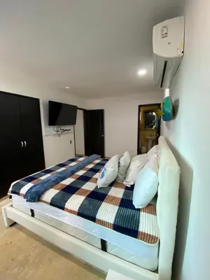 a bedroom with a bed with blue and white pillows at YOLO solo se vive una vez - MORROS Cartagena in Cartagena de Indias