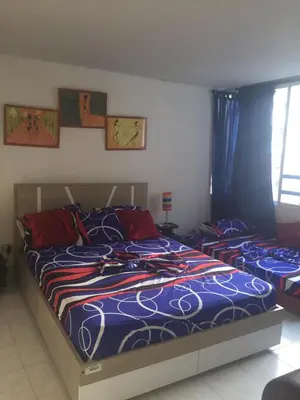 a bedroom with two beds with blue and red sheets at Apartamento en Cartagena, cerca al mar, edificio Nuevo Conquistador in Cartagena de Indias
