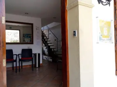 a hallway with chairs and stairs in a building at Casa Marqués del Pedregal in Cartagena de Indias