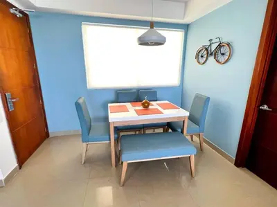 a dining room with a table and four chairs at Apartamento ideal frente al mar con vista espectacular in Cartagena de Indias