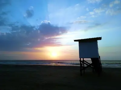 a lifeguard stand on the beach at sunset at Casa MAR de FE in Cartagena de Indias