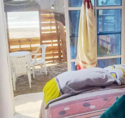 a bedroom with a bed and a view of the beach at Casa MAR de FE in Cartagena de Indias