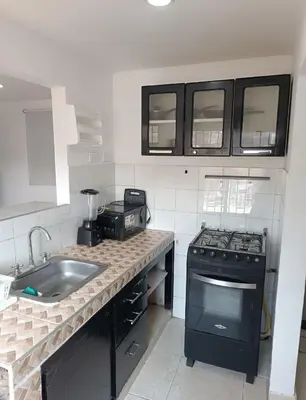a small kitchen with a stove and a sink at Hermoso apartamento in Cartagena de Indias