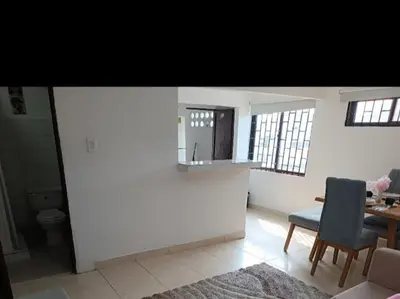 a living room with a table and a chair at Hermoso apartamento in Cartagena de Indias