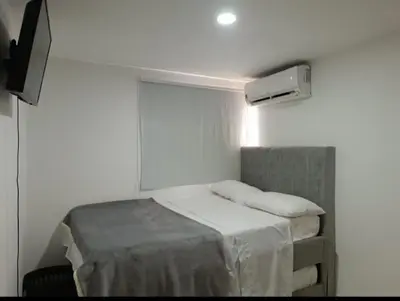 a small room with a bed and a heater at Hermoso apartamento in Cartagena de Indias