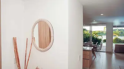 a mirror hanging on a wall in a living room at Villa Karibana Paradise in Cartagena de Indias