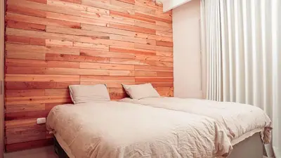 a bedroom with a wooden wall with a bed at Villa Karibana Paradise in Cartagena de Indias