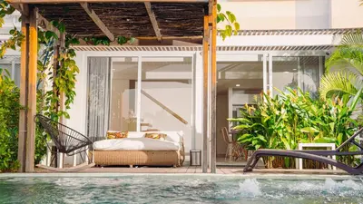 a bed on a patio next to a swimming pool at Villa Karibana Paradise in Cartagena de Indias