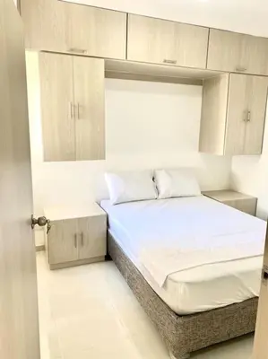 a small bedroom with a bed and white cabinets at Apartamento en Cartagena in Cartagena de Indias