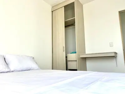 a bedroom with a white bed and a closet at Apartamento en Cartagena in Cartagena de Indias