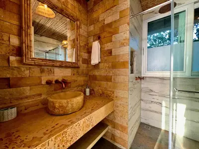 a bathroom with a large wooden sink and a mirror at Casa Luna Laguna Beach in Tolú