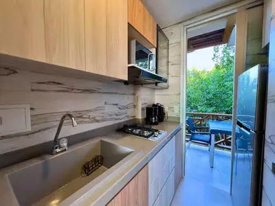 a kitchen with a sink and a view of a patio at Casa Luna Laguna Beach in Tolú