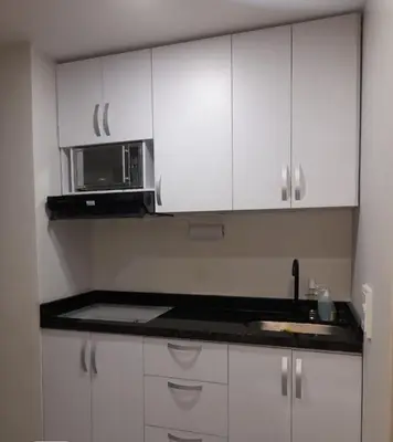 a kitchen with white cabinets and a microwave at Amazing Ocean View apartment with Pool in Laguito Cartagena in Cartagena de Indias
