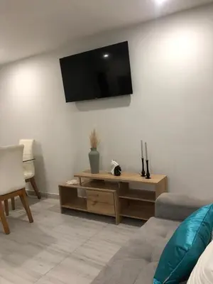 a living room with a flat screen tv on the wall at Amazing Ocean View apartment with Pool in Laguito Cartagena in Cartagena de Indias