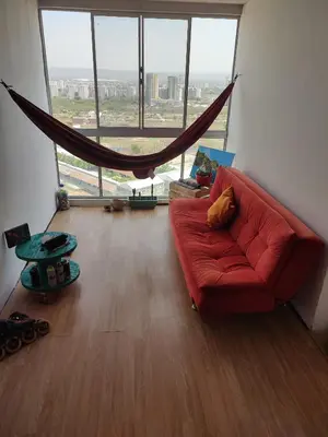 a red couch in a living room with a large window at habitación cartagena de indias en piso in Cartagena de Indias