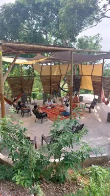 a group of people sitting under a pavilion at Puerta al Mar Ecolodge Glamping in Tubará